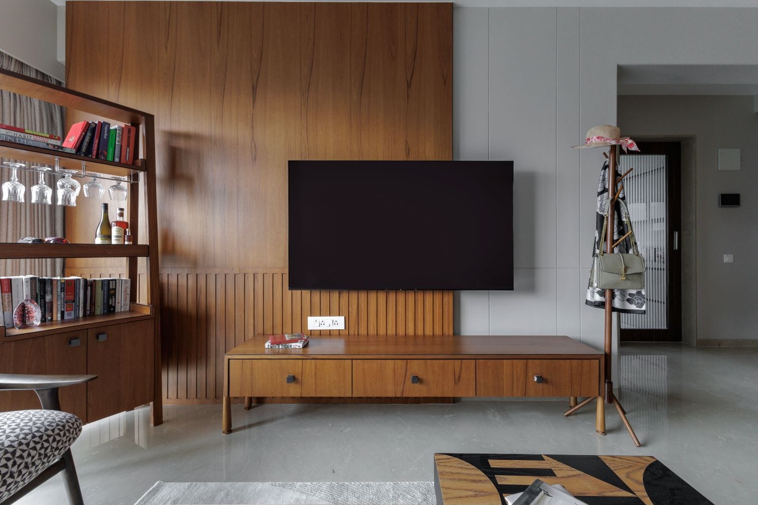 Elegant living room designed by Metamorphic Interior Design Studio based in Pune with modern wood finishes and minimalist decor